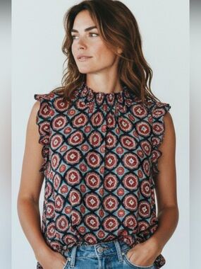 THML sleeveless blouse with smocked mock neck and ruffled cap sleeves. Size M